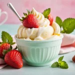 Swirled vanilla frozen yogurt in a pastel cup with strawberries and honey drizzle